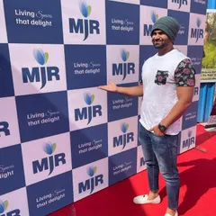 At the red carpet entrance for the MJR Builders property launch. I help create a vibrant atmosphere from the moment guests arrive.