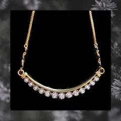 A very contemporary design, this mangalsutra has a curved bar set with a line of brilliant diamonds. It is minimal, chic, and perfect for daily office or casual wear.