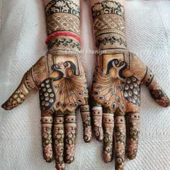 A bold and beautiful peacock design. The use of negative space makes the peacock's form stand out, while the fingers are decorated with delicate floral patterns.