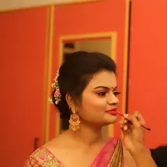 The final touch. In this photo, I am carefully applying lipstick for a client's reception look. A precise lip line is essential for a polished and long-lasting finish.