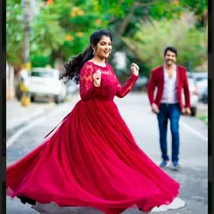 A moment of pure joy and dance. This deep red gown with delicate lace sleeves is perfect for capturing candid, happy moments during a pre-wedding or post-wedding shoot.