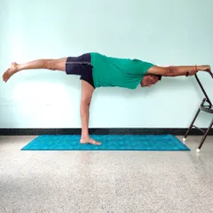 This is Veerabhadrasana 3 (Warrior 3 Pose) performed with the support of a chair. The chair allows you to hold the asana, focus on extending the spine and back leg, and build strength without compromising the alignment. This is how we make advanced postures accessible and safe for practice at home.