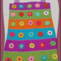This is a custom dress I made for a young client. It features colorful stripes and dozens of hand-stitched flower appliqués, making it a truly joyful and one-of-a-kind piece.