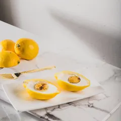 When life gives you lemons, we make dessert. This playful creation looks exactly like a lemon but is actually a delicate sweet, showcasing our passion for Indian fusion desserts that surprise and delight the senses.