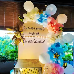 A sweet and modern baby shower or gender reveal backdrop. The pastel blue and pink balloon arrangement is complemented by a personalized message celebrating the family's new arrival.