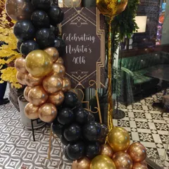 We created a custom welcome sign for Nishita's 40th birthday, designed in a sophisticated Art Deco style. The black and gold balloon arrangement ties the whole look together.