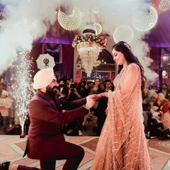 The grand proposal is a moment that deserves a spectacular shot. I use the dramatic lighting from pyrotechnics and the grand decor to frame this unforgettable memory.
