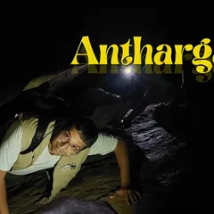 A trekker navigating the narrow passages of the Anthargange caves. It's a thrilling experience that tests your flexibility and courage.