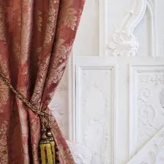 The epitome of classic elegance, this "Foscarini" damask curtain by Nobilis Paris showcases a delicate floral pattern woven into a sophisticated strié warp. Paired with an ornate tassel tie-back, it exemplifies our dedication to traditional craftsmanship and luxurious drapery solutions that add a layer of grandeur to a room.