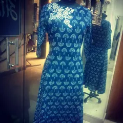 This long indigo kurta features a traditional block-print style pattern. To elevate the design, I added a contrasting white floral embroidery motif around the neckline, making it a unique piece for semi-formal wear.