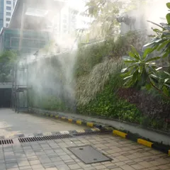 Here is a vertical garden we maintain, with its integrated misting system in action. Proper irrigation is critical for the health of a green wall, and our team ensures these technical systems are always functioning perfectly to keep the foliage dense and vibrant.
