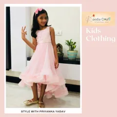 This elegant high-low gown in baby pink is perfect for a young girl attending a wedding or formal party. The dress features a detailed bodice and a ruffled hemline that adds a touch of sophisticated fun. Image 40 shows the dress in motion.