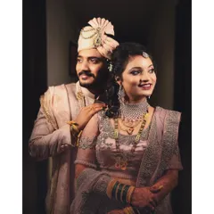 A stunning portrait of the couple on their wedding day, showcasing their elegant outfits and happy smiles.