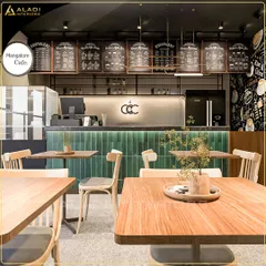 A wider perspective of the cafe interior, showing the relationship between the seating area and the service counter, emphasizing the open and welcoming layout.