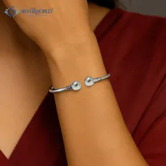 Our urban minimalist bangle is a classic open-ended design with ball accents and rustic detailing. It's a versatile and sturdy piece for everyday wear.
