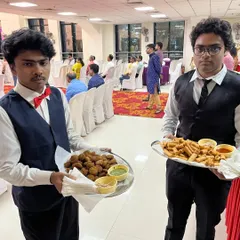 My staff serving different starters like hara bhara kabab and veg spring rolls at a naming ceremony in Airoli. Passed service ensures all guests are attended to.