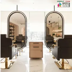 Custom-designed styling stations at 'Frumos' salon. The suspended, black-framed oval mirrors are a key feature, adding a touch of modern elegance and creating a sense of lightness in the space.