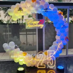 This shot highlights the lighting I used for the 25th anniversary balloon arch. By using different colored floor lights, I can change the mood of the decor to match your event's theme, as seen here with the blue and yellow tones.