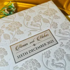 A close-up shot of the embossed texture. The raised floral pattern on premium paper creates a sense of classic luxury and meticulous craftsmanship.