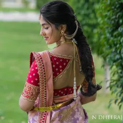 A statement back can transform an entire outfit. For this bride, I created a custom red raw silk blouse with intricate zari and zardosi embroidery, featuring a unique back design that perfectly complements her lavender Kanchivaram saree.