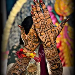 A classic bridal pose showing the rich stain of a detailed wedding mehndi. The design features traditional elements perfect for a wedding ceremony.