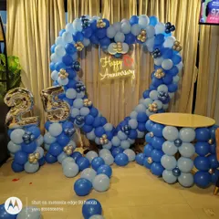 Here is a grand heart-shaped balloon arch I created for a 25th anniversary celebration. The blue and silver color scheme, combined with the large '25' foil balloons and a 'Happy Anniversary' neon sign, makes for a perfect photo backdrop at any party venue.