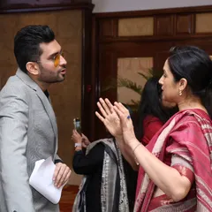 A candid moment of interaction with a guest at the Mirae Asset event. Engaging with attendees off-stage is just as important as on-stage performance.