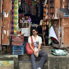 Finding beauty in ruins. A self-portrait in front of a cluttered old shop, celebrating the aesthetic of places that are full of character and stories.