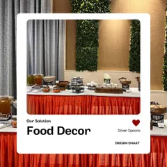 A wide view of a food station with a red table skirt and green wall panels. The clean lines and organized layout demonstrate my focus on professional food decor.