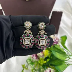 A close-up of the earrings from this kundan set, showing the intricate floral design.