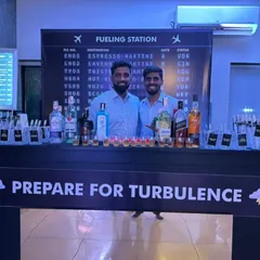 Prepare for turbulence! This airport-themed 'Fuelling Station' bar was a huge hit. The design featured a flight departure board menu and a bar front that set the stage for a night of adventure.