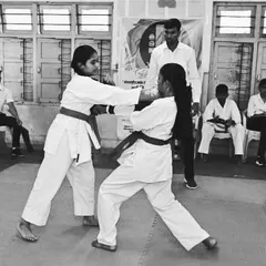 Two of our young karate students demonstrate their kumite (sparring) skills during a belt examination. These exams are important milestones, testing not just technique but also courage, control, and respect for one's opponent.