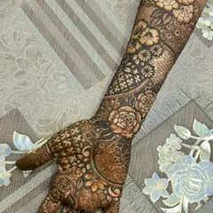 A complete back-of-hand bridal design extending up the forearm. This piece features beautiful rose motifs combined with geometric grids and leafy patterns for a balanced look.