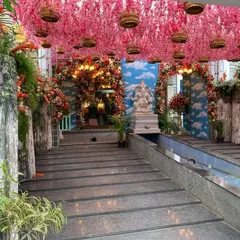 Another angle of the grand naming ceremony entrance, showing the Ganesha statue and the path leading into the hall. The decor creates a seamless, immersive experience for guests.