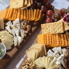 A close-up of our classic cheese and charcuterie board, featuring a selection of premium cheeses, crackers, nuts, and grapes. This was part of our catering for Netflix's 'Fabulous Lives of Bollywood Wives'.