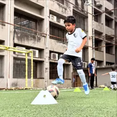 Mastering the ball is key. Here, a player practices a step-over on a stationary ball, building the muscle memory needed for advanced dribbling techniques.