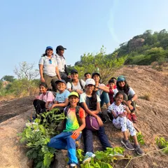 A happy group of our Young Adventurers and their instructors posing for a photo on the rocks during a hike. We focus on creating a fun, safe environment where kids can build confidence and make new friends.