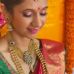 A close up of Pragati's makeup, showing the soft pink eyeshadow with a hint of shimmer. This style adds a touch of modern glam to a traditional look, making the eyes pop without being overpowering.