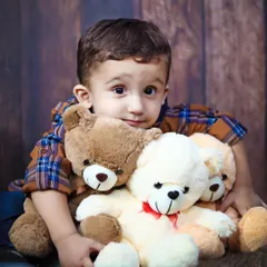A sweet toddler portrait, hugging his teddy bears. These sessions are perfect for capturing the bond between a child and their favorite toys.