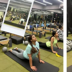 Grab your workout partner and let's flow, flex, and feel good together. This image captures the fun of a buddy workout, with clients doing mat exercises side-by-side.
