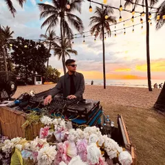 I also specialize in creating the perfect vibe for more intimate, scenic events. Here I am spinning a sunset set at a beautiful beachside gathering, blending music with the magic of the moment.