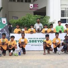 A team proudly displays their saplings as part of my #GoalsBeyondGoals initiative. I teach young athletes the importance of giving back to the community.