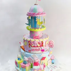 This huge Peppa Pig party cake was so much fun to create. It features a handmade rotating carousel on top and a mini Ferris wheel, bringing the entire carnival theme to life.