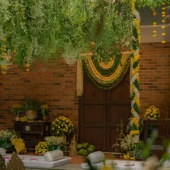 This is my modern take on a traditional South Indian wedding mandap. I used a lush canopy of fresh greenery and marigold strings, paired with a classic floral toran over the doorway, to create a space that feels sacred, authentic, and deeply personal.