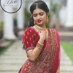 A closer view of the bride's makeup and velvet lehenga. I used a classic red lip and softly defined eyes to create a look of pure elegance. The focus is on flawless skin and a regal poise that befits a bride on her wedding day.
