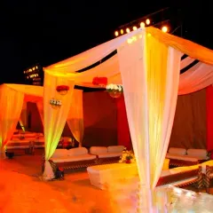 I can create comfortable lounge areas within a larger event space using these canopy setups. Furnished with sofas and soft lighting, these "kenopis" offer guests a relaxed space to sit and talk.