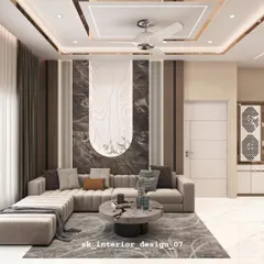 This living room design features a beautiful L-shaped sofa and a statement wall with contrasting marble and wood textures. The false ceiling with cove lighting adds a warm, inviting glow to the entire space.