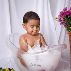 Splash time! After the cake smash, a milk bath is the perfect way to clean up and capture some more adorable, playful moments.