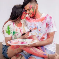 A messy and joyful moment from a Holi-themed pre-wedding shoot. Using paint is a fun, creative way to capture your colorful love story.