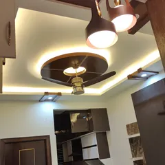 The finished look of a living room ceiling after our polishing work. The dark, glossy wooden panels contrast beautifully with the white ceiling, creating a modern design feature that draws the eye upward.
